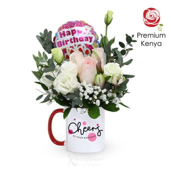 pink rose arrangement in cup with happy birthday balloon 