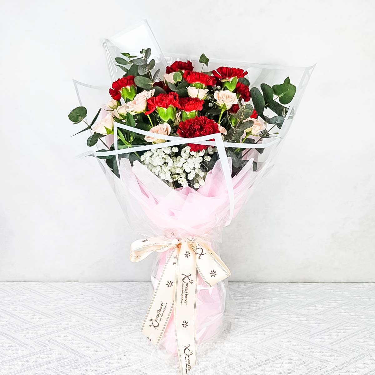 Crimson Charm (12 Red Carnations with Pink Rose Sprays)